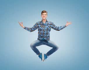 Obraz premium smiling young man jumping in air