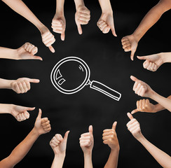 hands showing thumbs up in circle over magnifier