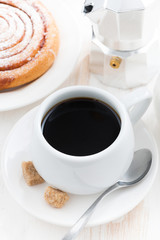 black coffee and sweet bun for breakfast, top view