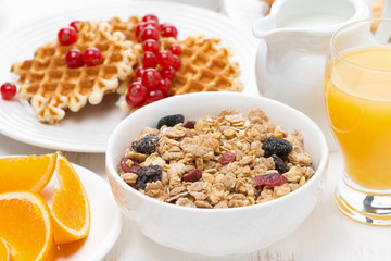 muesli, waffles with fresh berries and orange juice