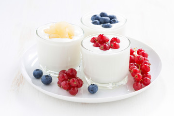 Natural yogurt with fresh berries in glass jars