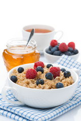 oat porridge with fresh berries and honey, a cup of black tea
