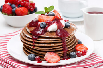 pancakes with cream, fruit sauce and berries