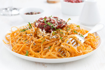 spaghetti with tomato sauce and parmesan, close-up