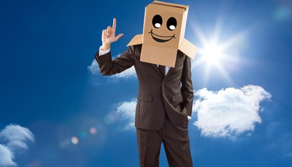 Composite image of anonymous businessman pointing up with finger