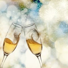 New Year's - toasting with champagne glasses against fireworks a