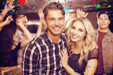 Composite image of stylish couple smiling and dancing together - obrazy, fototapety, plakaty