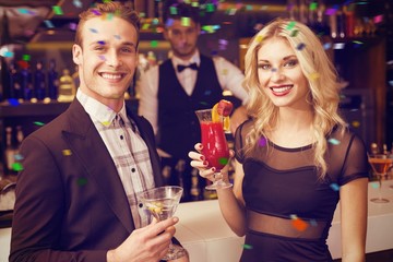 Attractive friends drinking cocktails together