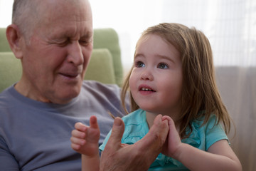 Cute little girl holding her grandfather's hand