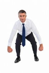 Businessman bending and clenching fists