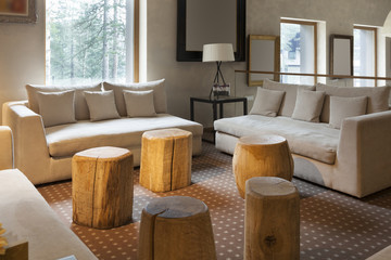 Modern hotel lobby cafe interior with logs as chairs 