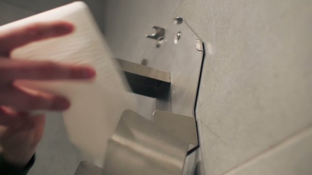 Taking out whole roll of toilet paper.