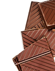 Chopped chocolate bar isolated on white background. Dark chocola