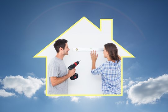 Composite image of man and his wife doing diy together