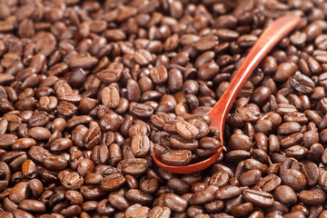 Wooden spoon with coffee beans