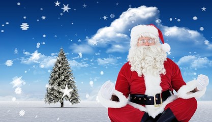 Composite image of santa claus sitting in lotus pose