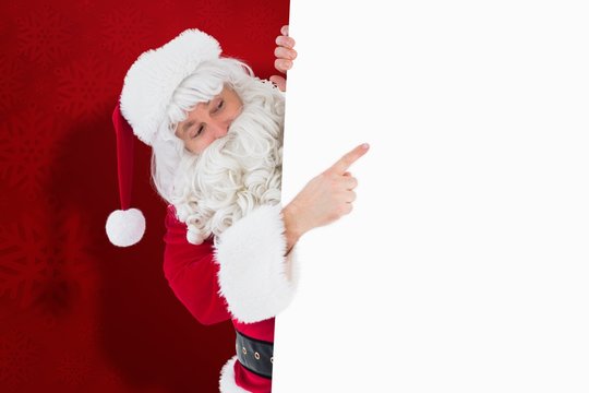 Composite image of festive father christmas presenting sign