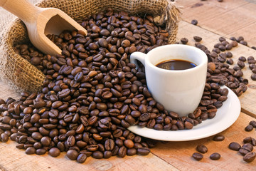 coffee cup and grains on wooden table