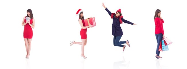 Composite image of festive brunette holding gift bags