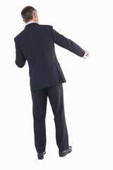 Businessman in suit standing and doing gesture