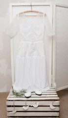 Vintage wedding dress and shoes on a wooden background