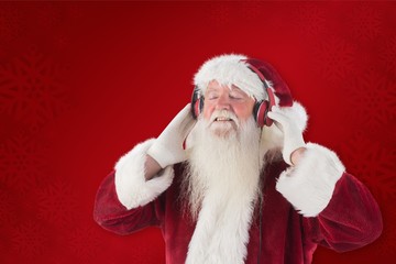 Composite image of santa claus enjoys some music
