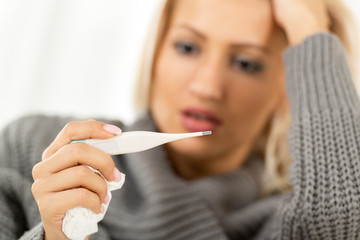 Worried Girl With Digital Thermometer