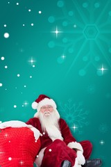 Composite image of santa sits next to his bag