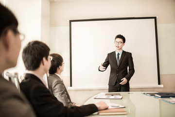 businessman giving a presentation to his colleagues