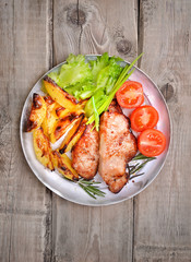 Pork steaks on rustic table, top view
