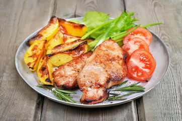 Grilled pork chop on rustic table