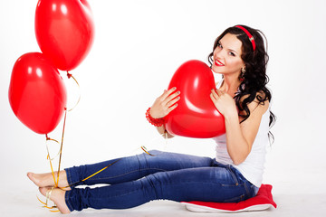 Sexy brunette with balloons heart in studio