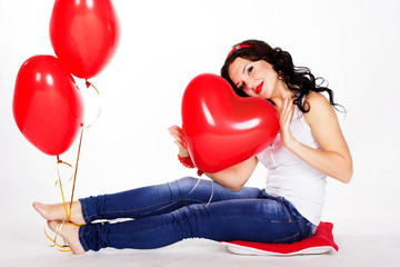 Fototapeta na wymiar Sexy brunette with balloons heart in studio