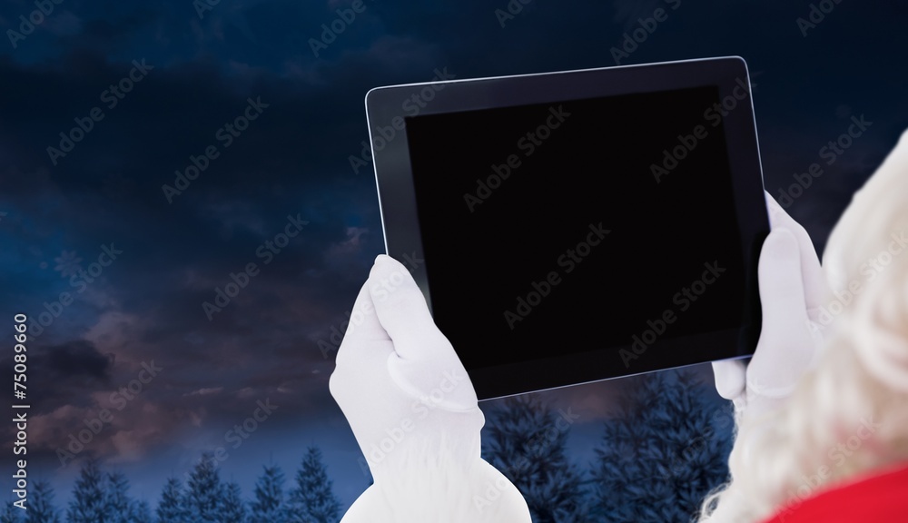 Poster composite image of santa claus using tablet pc