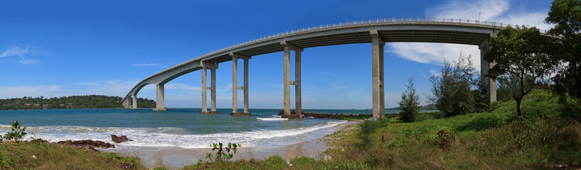 Tropical panoramic view of sea with a high bridge to an island