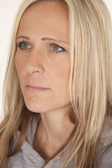 A woman close face blond looking to side