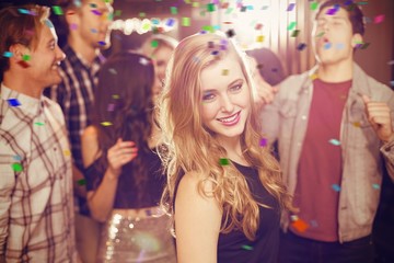 Obraz na płótnie Canvas Composite image of stylish blonde smiling at camera
