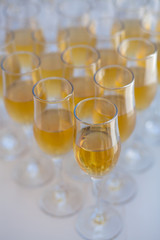 lot of glasses filled with champagne on the party table