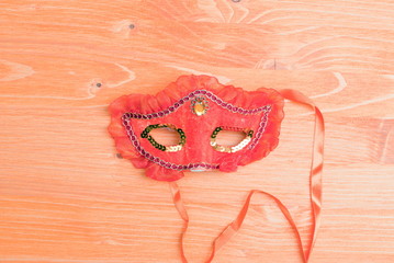 beautiful mask of feathers on a yellow board