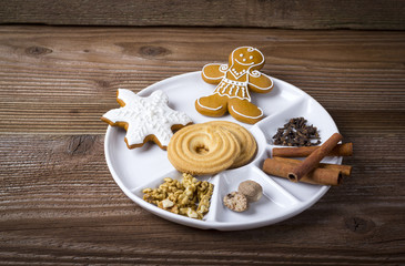 Sweets in a plate on wooden background