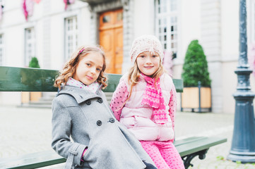 Outdoor portrait of two adorable little girls