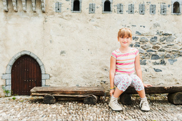 Outdoor portrait of adorable little girl playing in a park