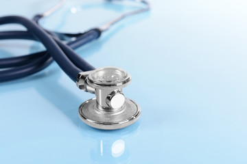 Stethoscope on light blue background