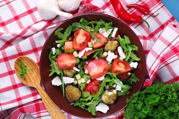 Eggplant salad with tomatoes, arugula and feta cheese,