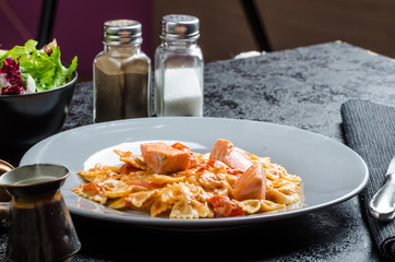 Farfalle with tomato sauce and roasted salmon