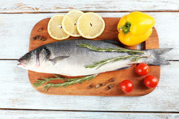 Fresh raw fish and food ingredients on table