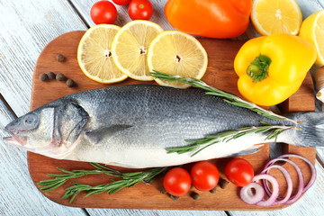 Fresh raw fish and food ingredients on table