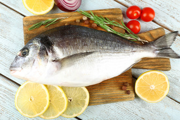 Fresh raw fish and food ingredients on table