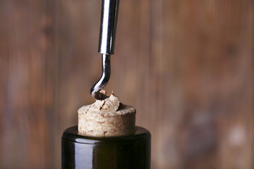 Bottle opener close-up, on wooden background