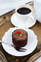 Yummy chocolate cupcake and cup of coffee on tray